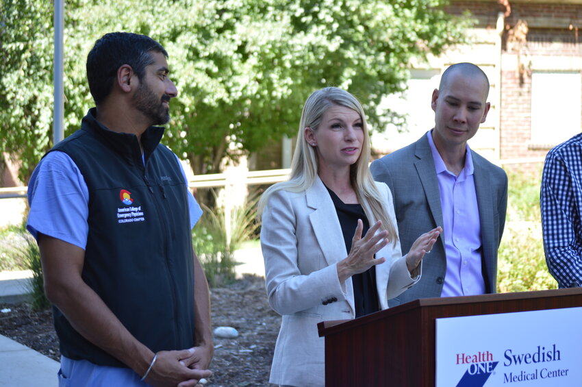 From left to right: Ricky Dhaliwal, representing the American College of Emergency Physicians, watches U.S. Rep. Brittany Pettersen speak Aug. 31, 2023, about the Hospitals As Naloxone Distribution Sites (HANDS) Act. Standing to the far right is Don Stader, the executive director of The Naloxone Project.